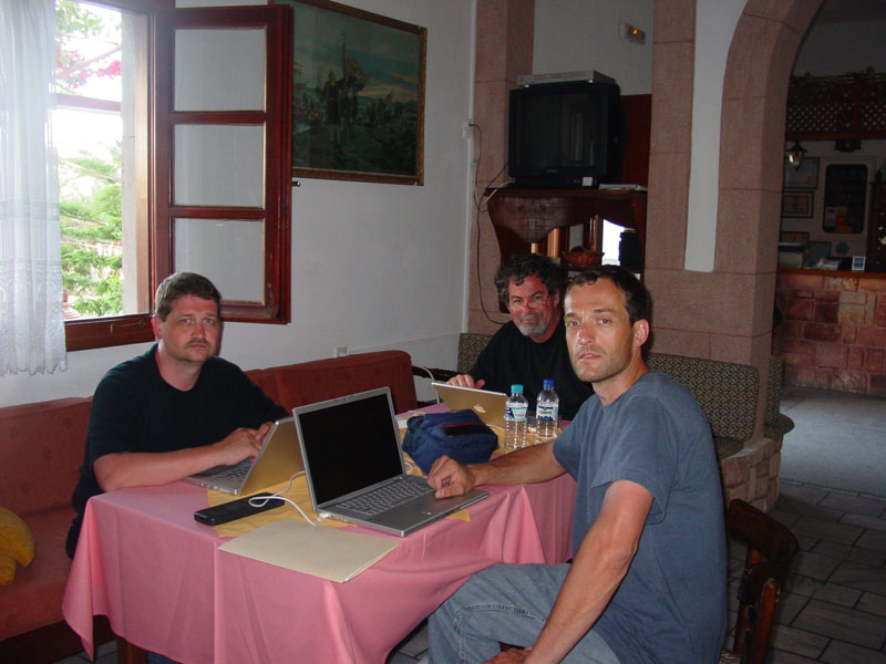 Three CSNTM team members working at a table.